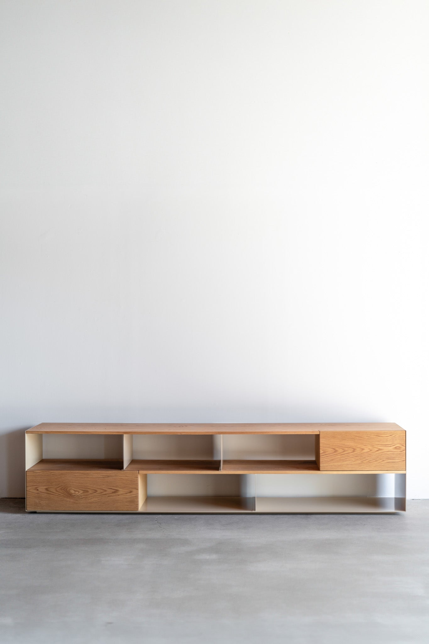 Full shot of low metal and wood bookcase