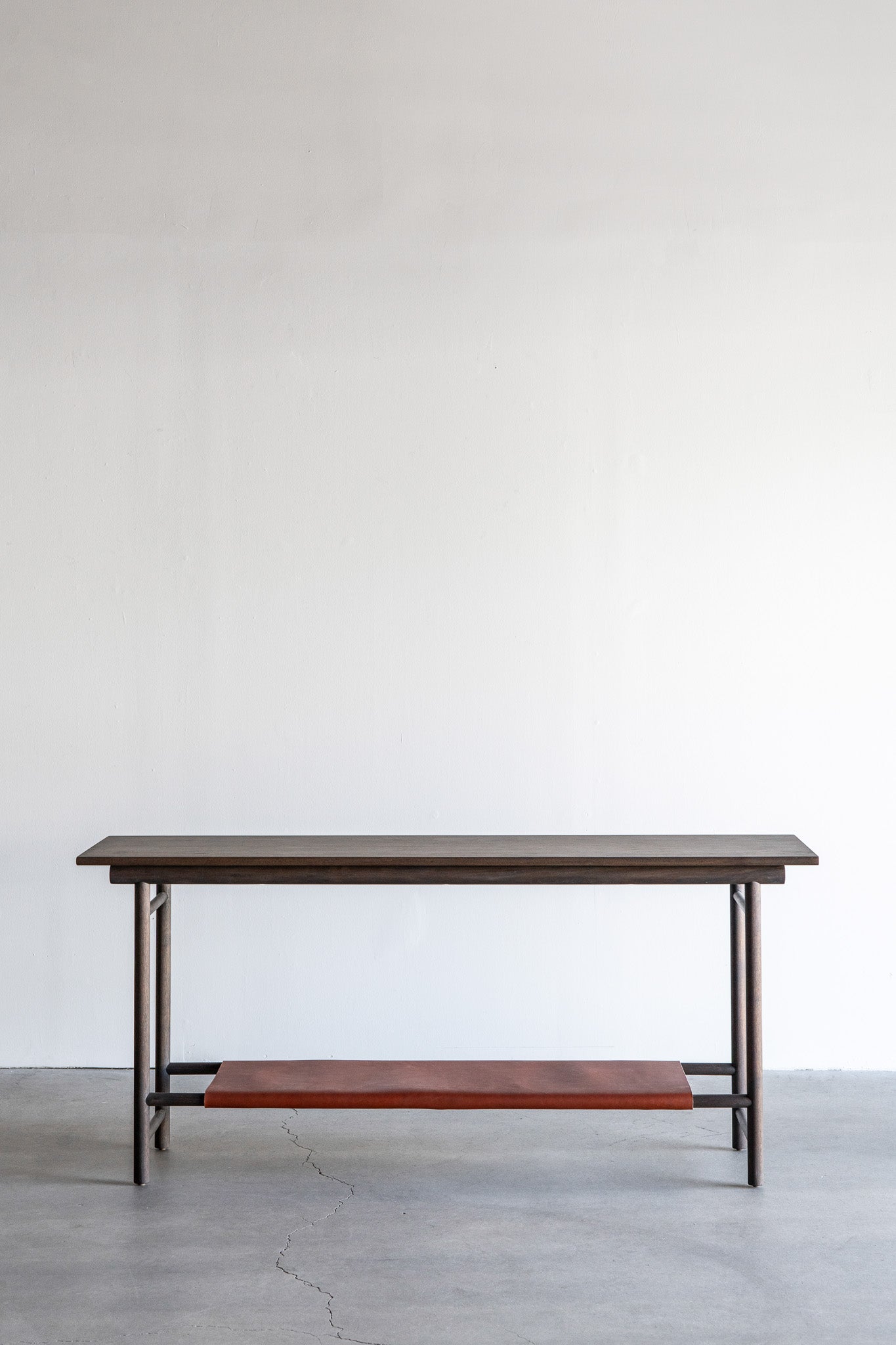 Reyes console- solid walnut, structural leather shelf