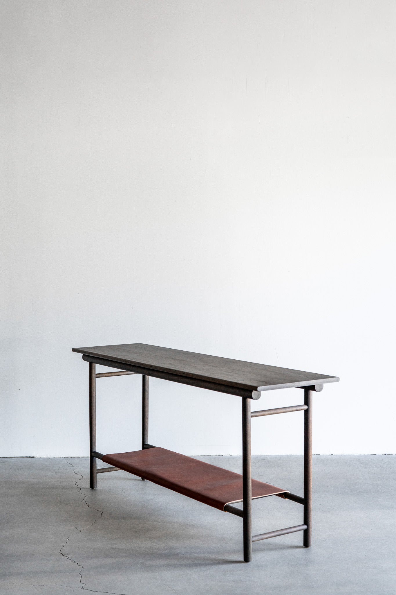 Reyes console- solid walnut, structural leather shelf