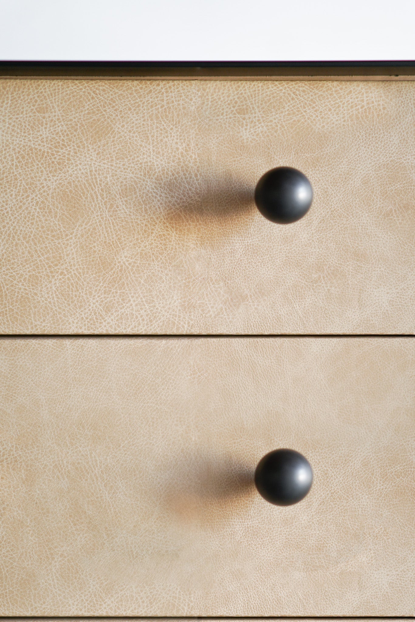 Leather and metal long dresser close up of knobs