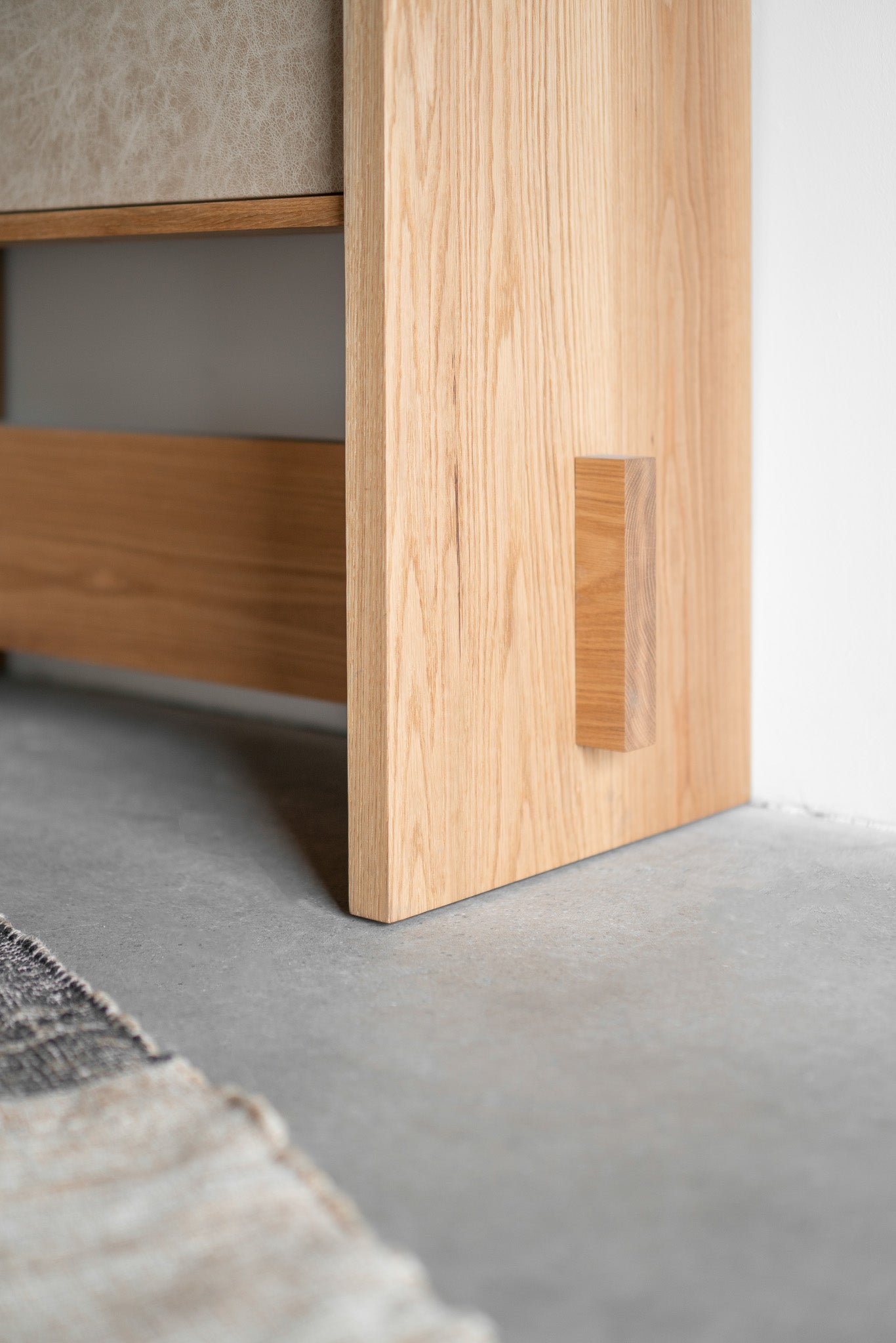 Carter Armoire - all wood armoire , close up on bottom left corner 