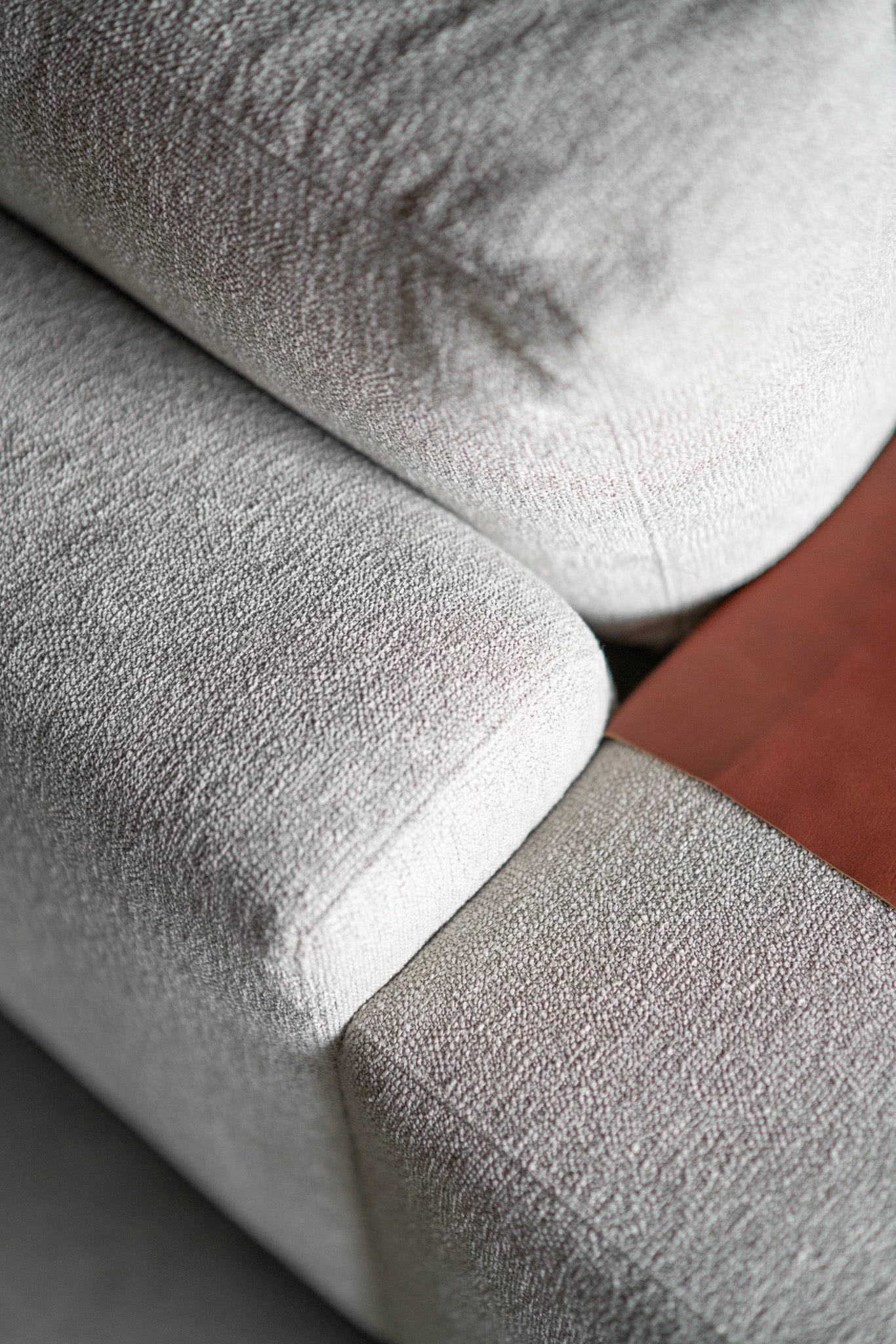 close up shot of sofa with leather arm 