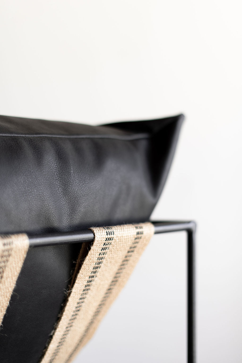 Black leather sierra chair -close up on steel frame 