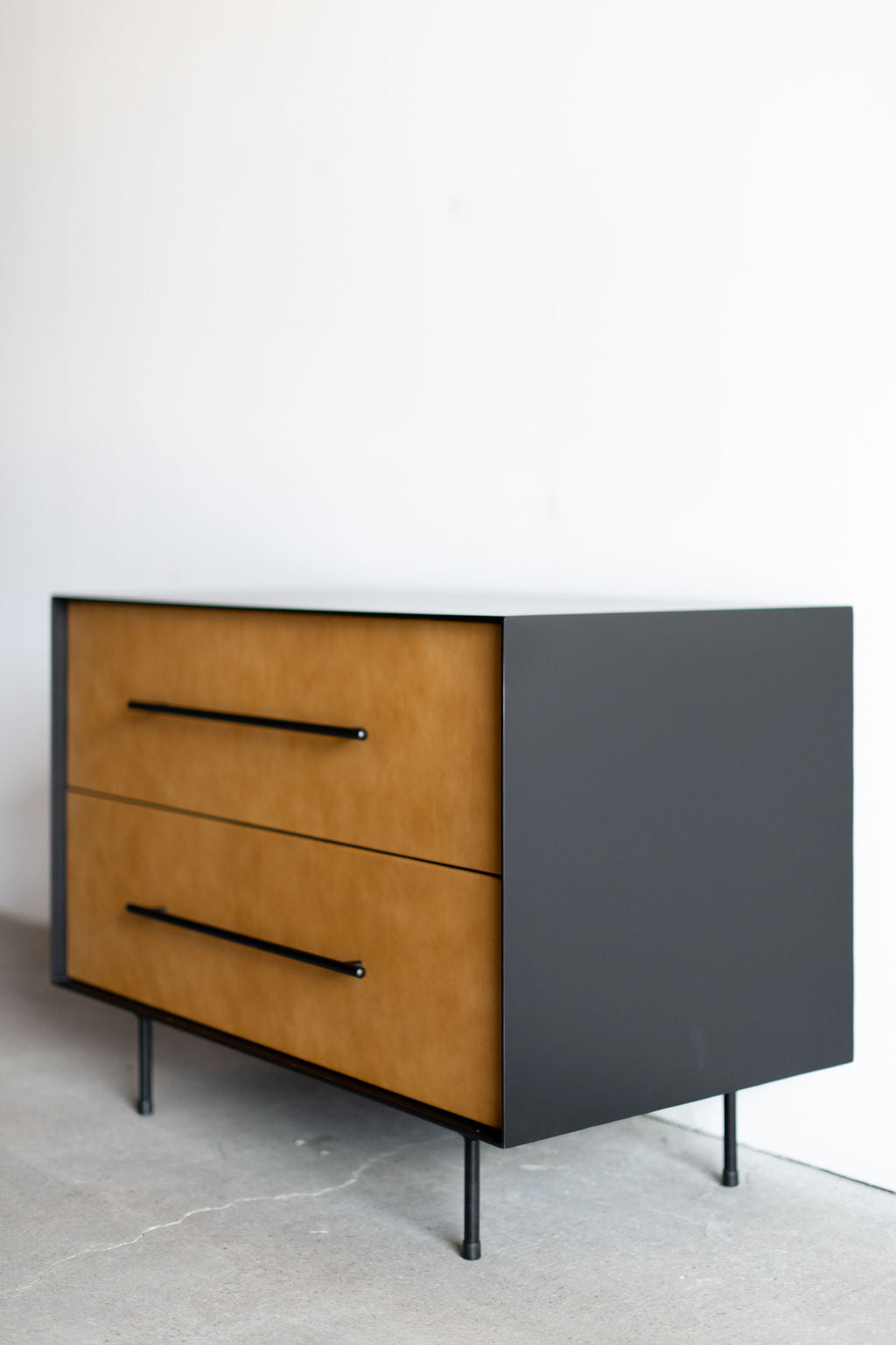 Full left side shot of Bronson nightstand- Metal casing with leather drawer faces 