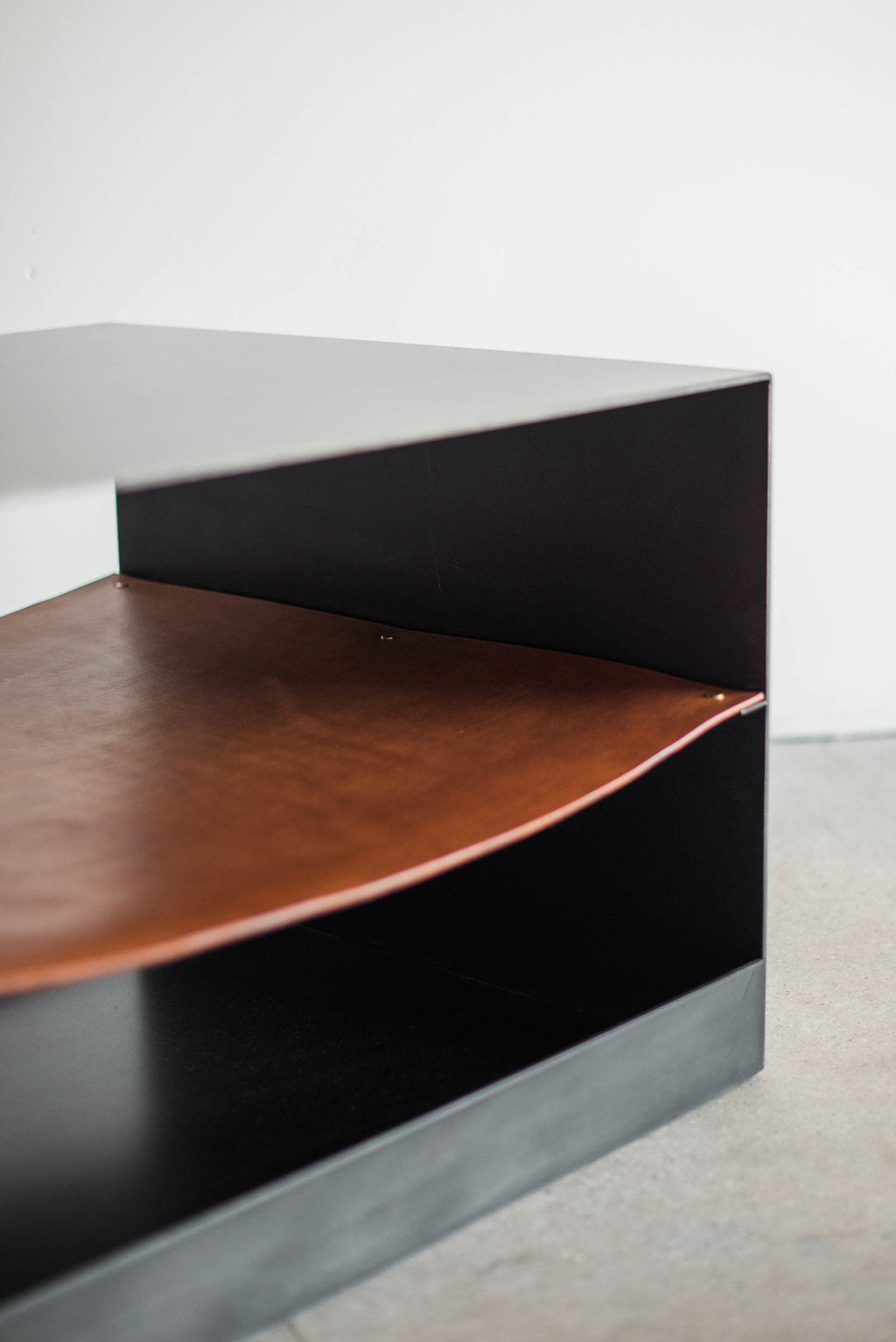 Latigo side table - side shot of leather and metal casing