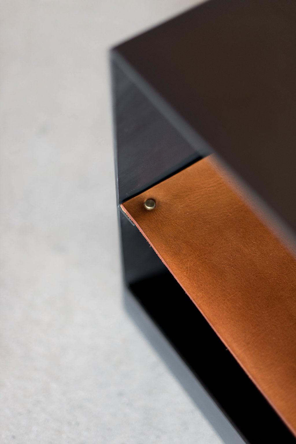 Latigo side table - close up on leather and metal casing 
