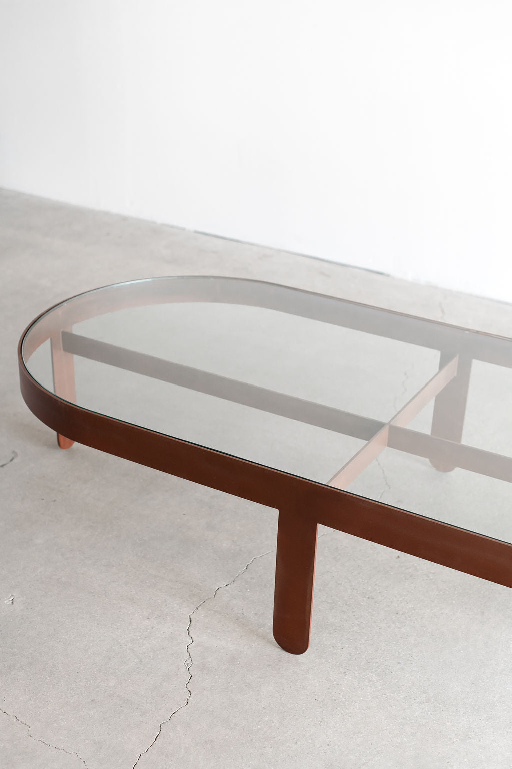 Palmas coffee table Oval - steel patina frame with glass top 