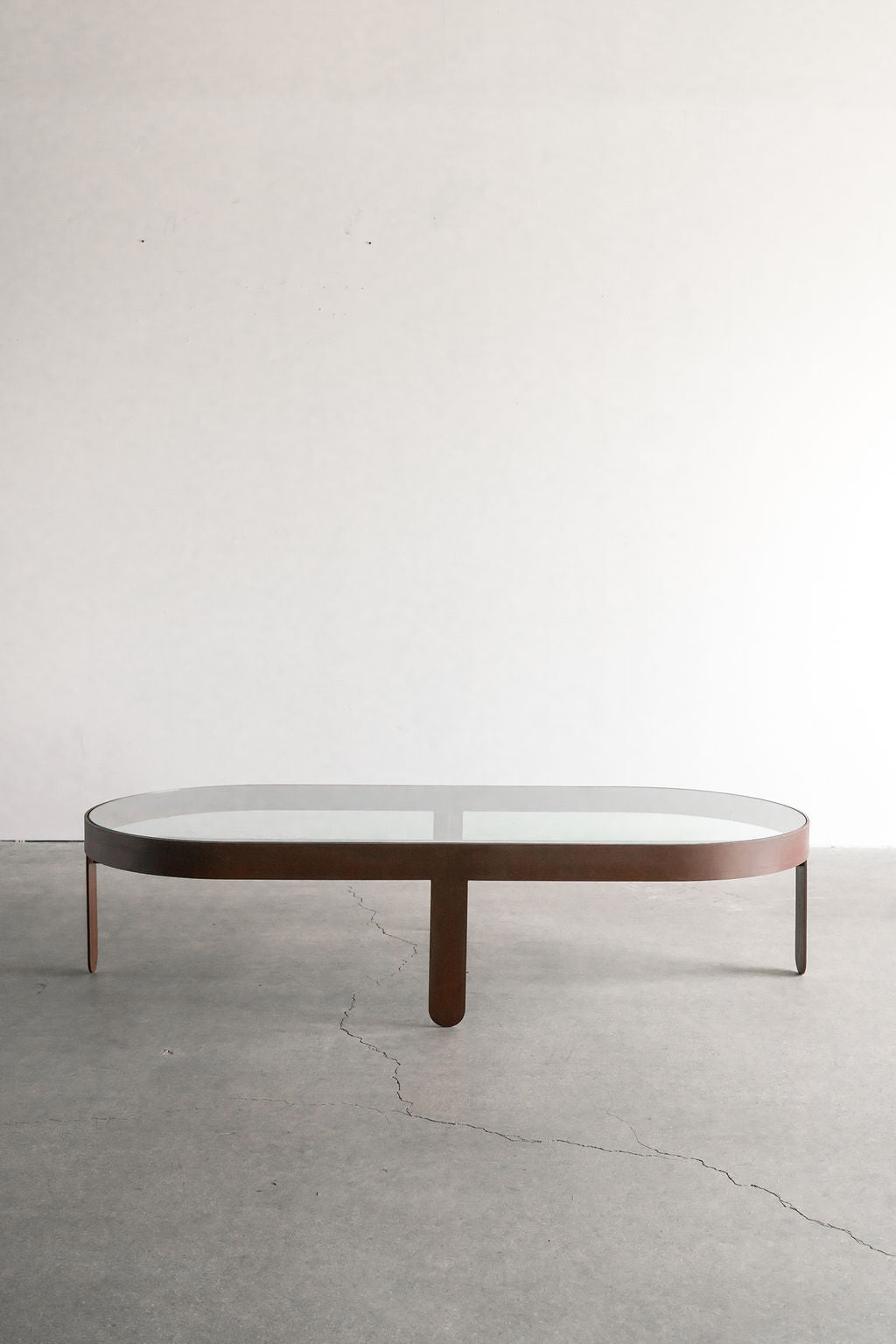 Palmas coffee table Oval - steel patina frame with glass top