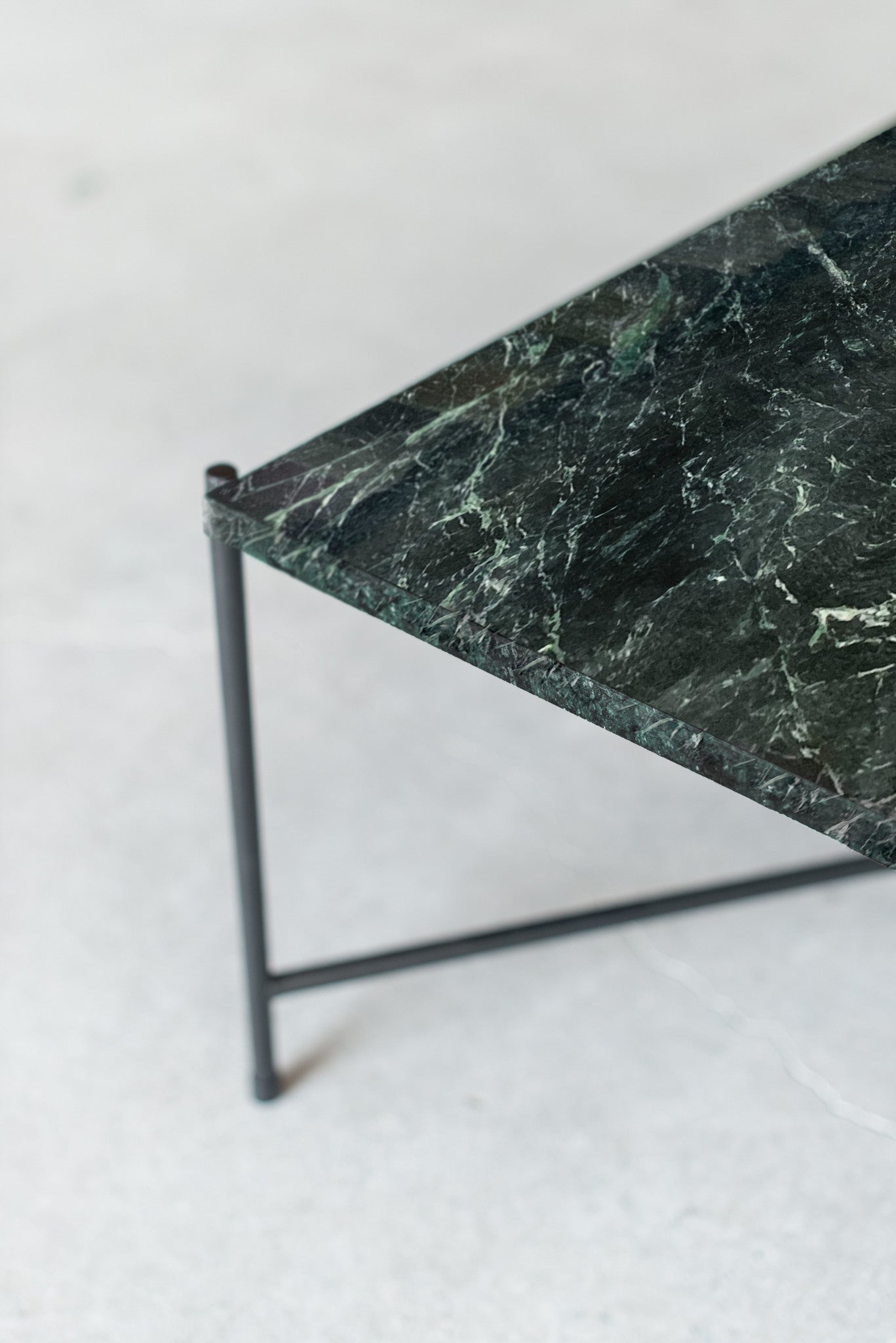 Marble coffee table - side shot of steel legs and marble top 