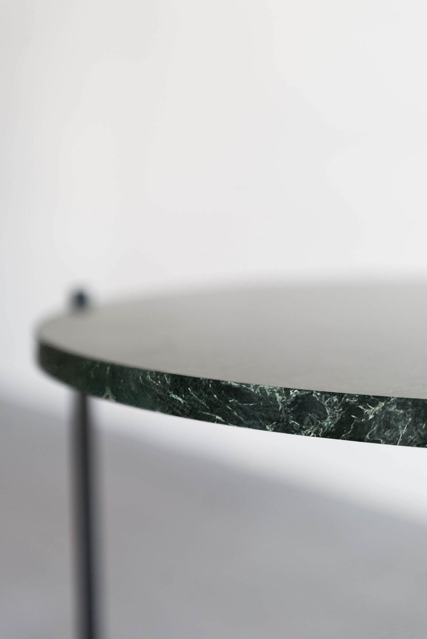 empress green side table - focus on side of marble top 
